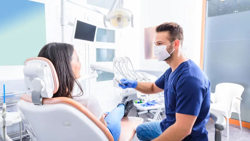 Dentist reviewing a dental image with a patient