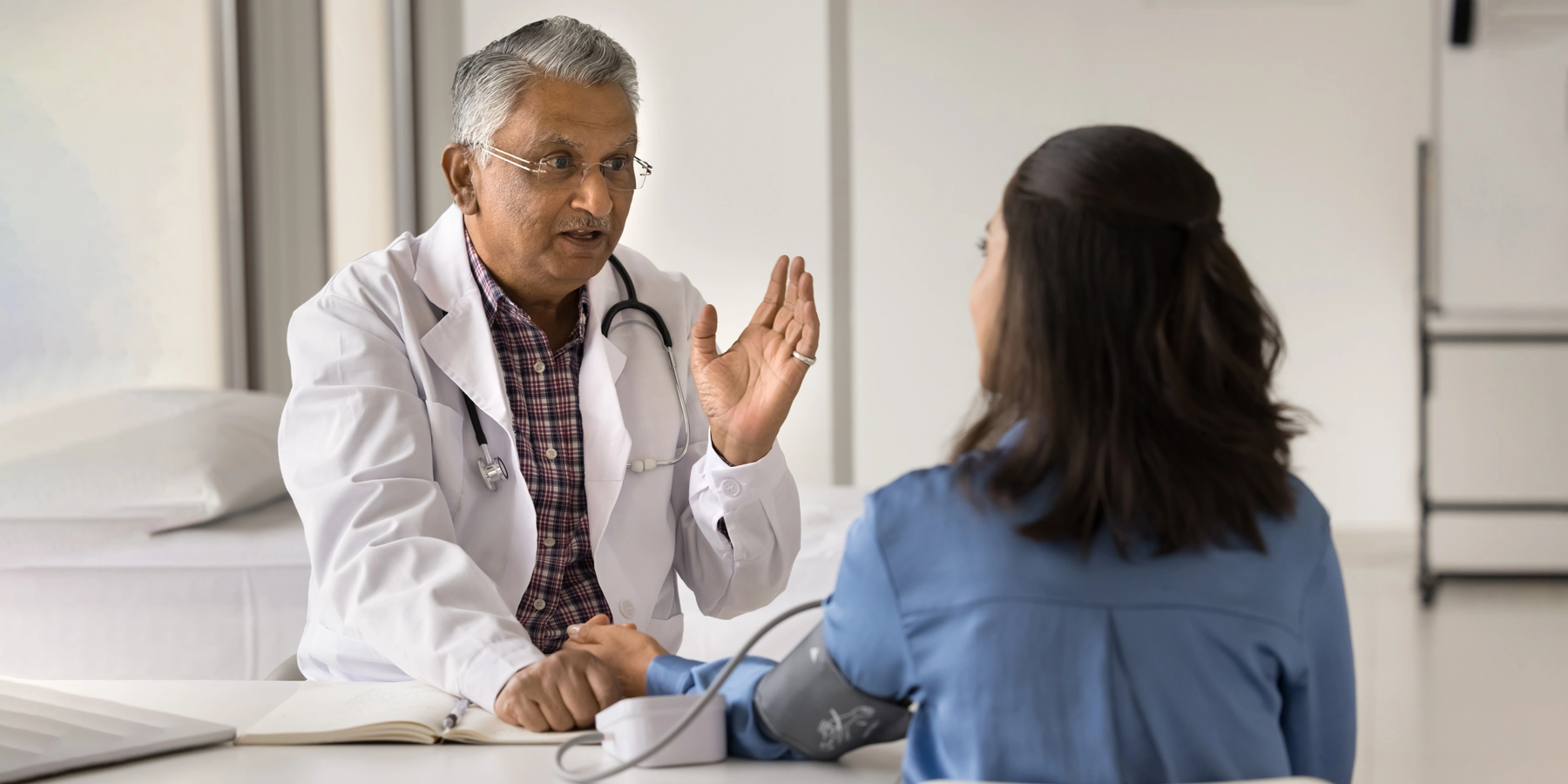 General physician speaking with a patient during a consultation