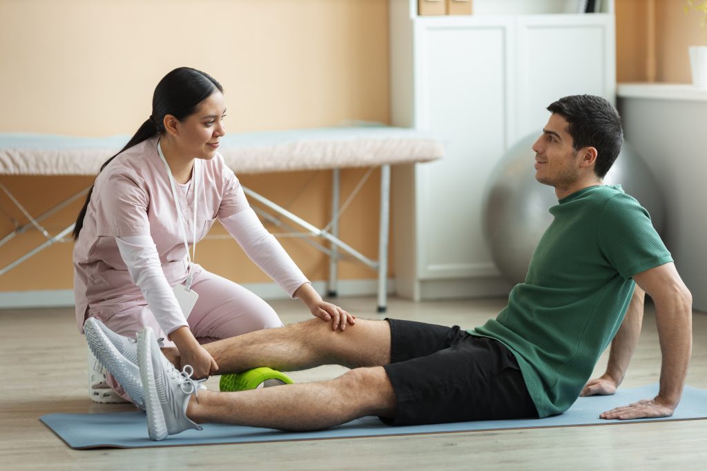Physiotherapist helping a patient during a rehabilitation session