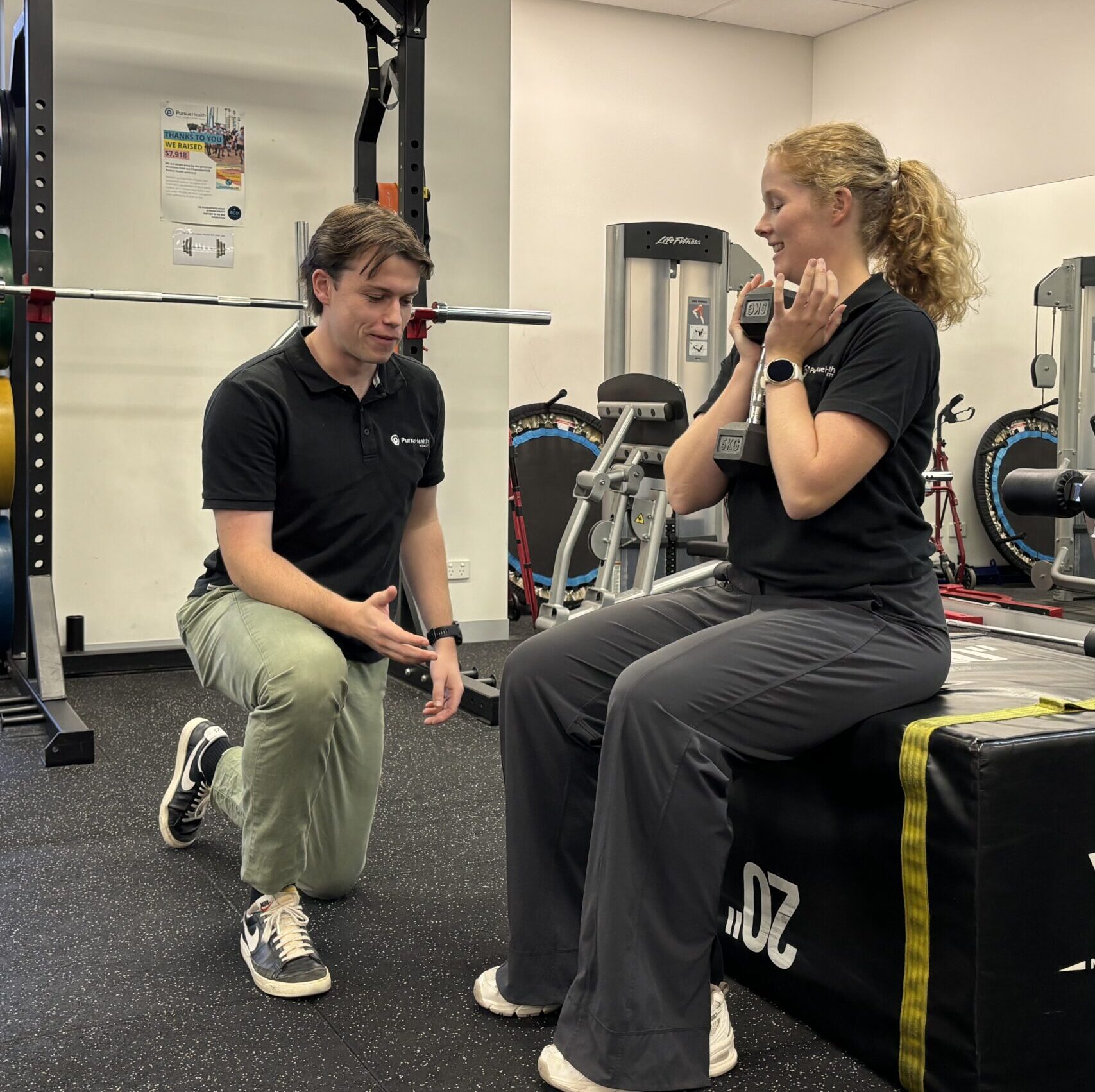 Physiotherapist supporting a patient during a mobility exercise
