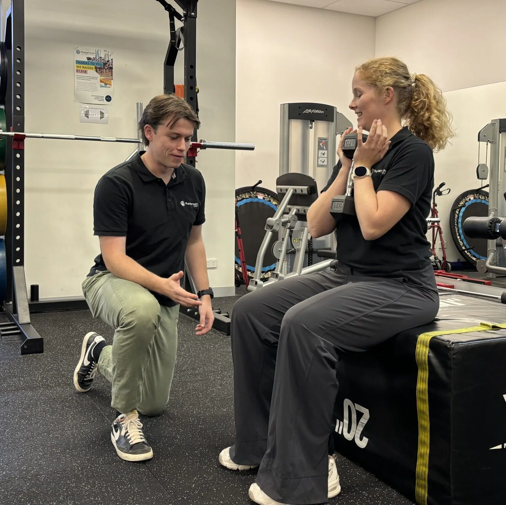 Physiotherapist supporting a patient during a mobility exercise