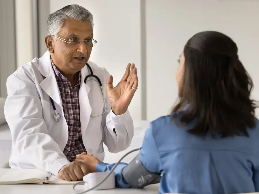 A general physician in consultation with a patient